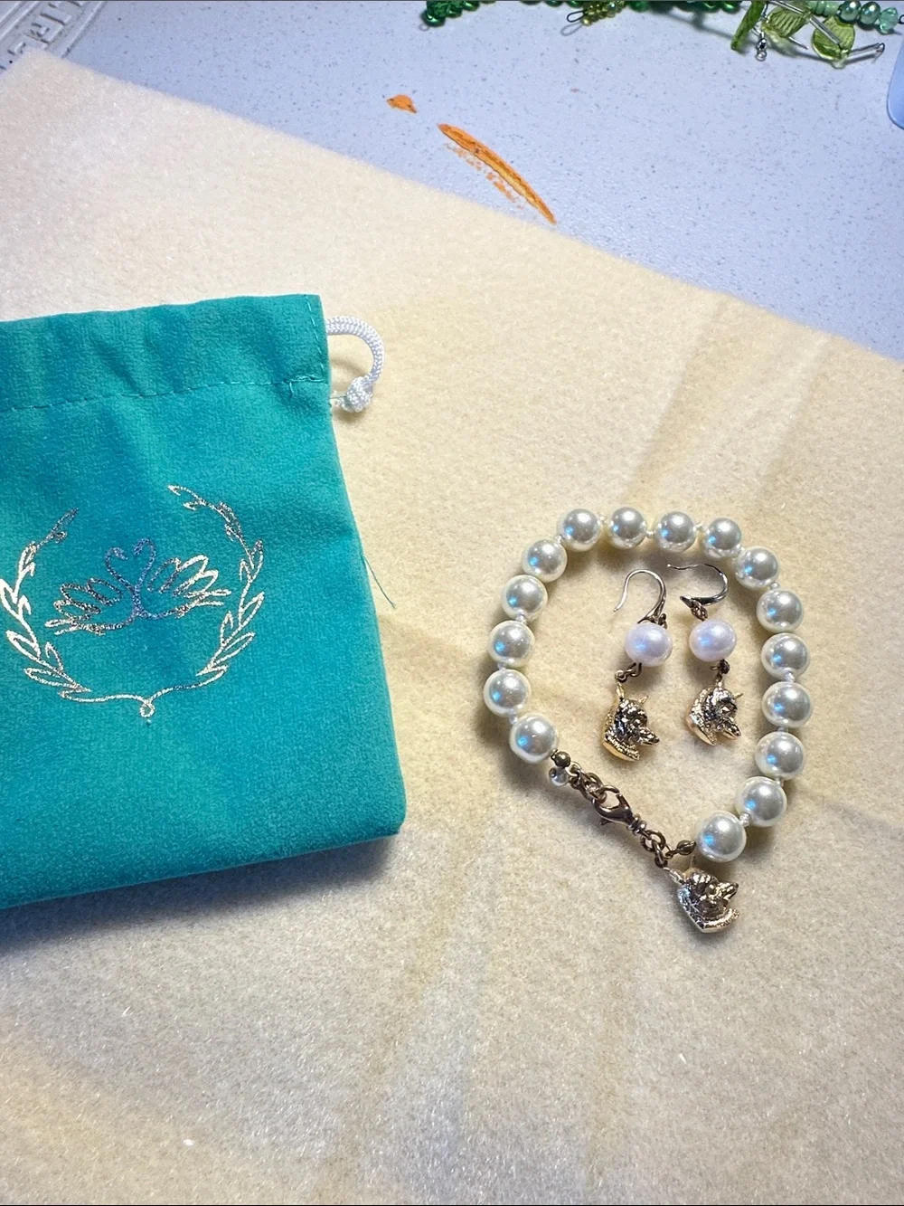 Kiel James Patrick Teal Pouch with Pearl Bracelet and Fox Charm Earrings